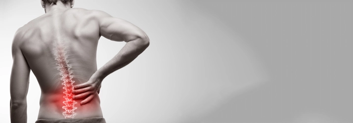 Man holding his lower back with a red spine.